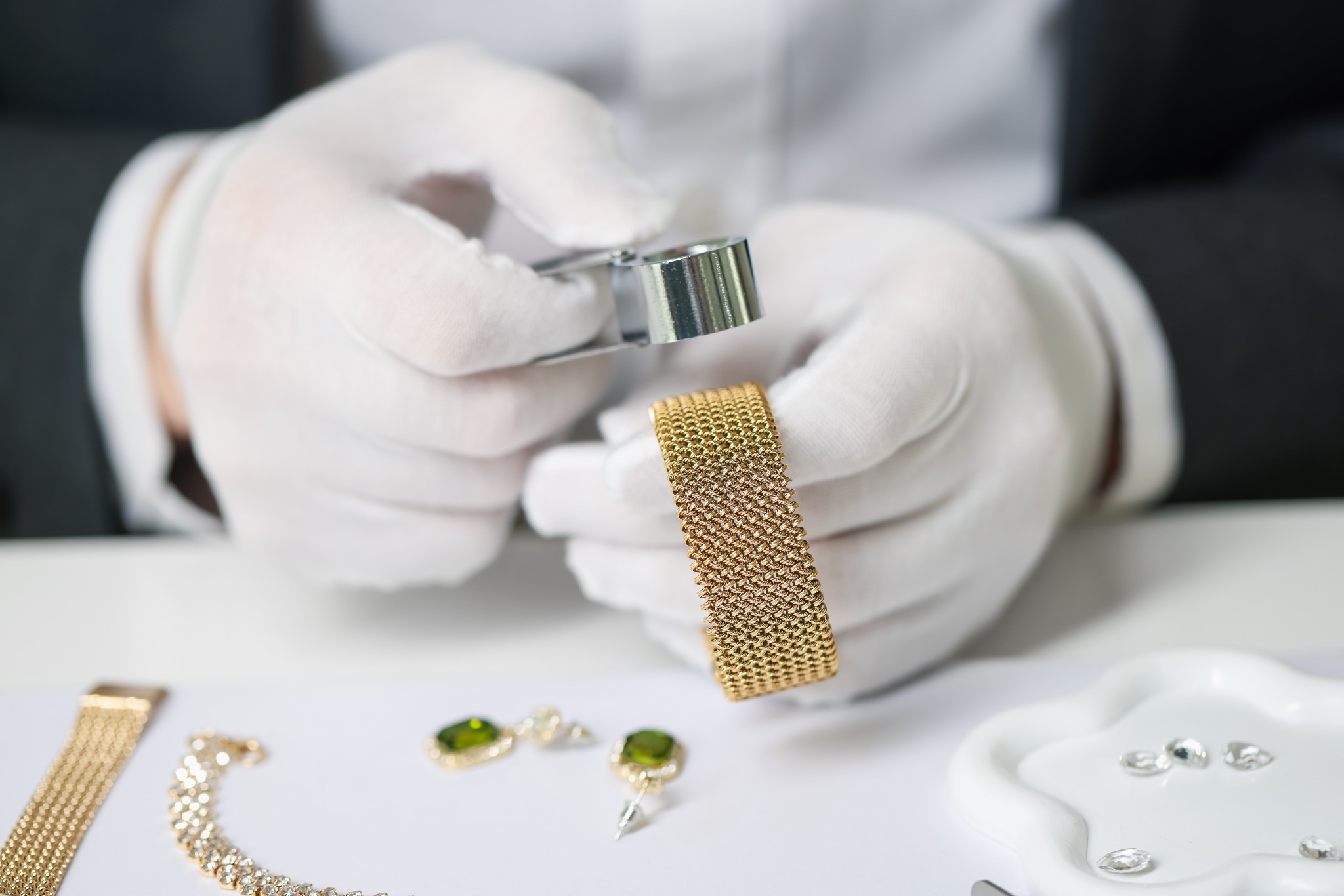 Gold bracelet examined carefully under magnification